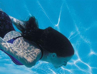 A woman with a Hayward pool cleaner